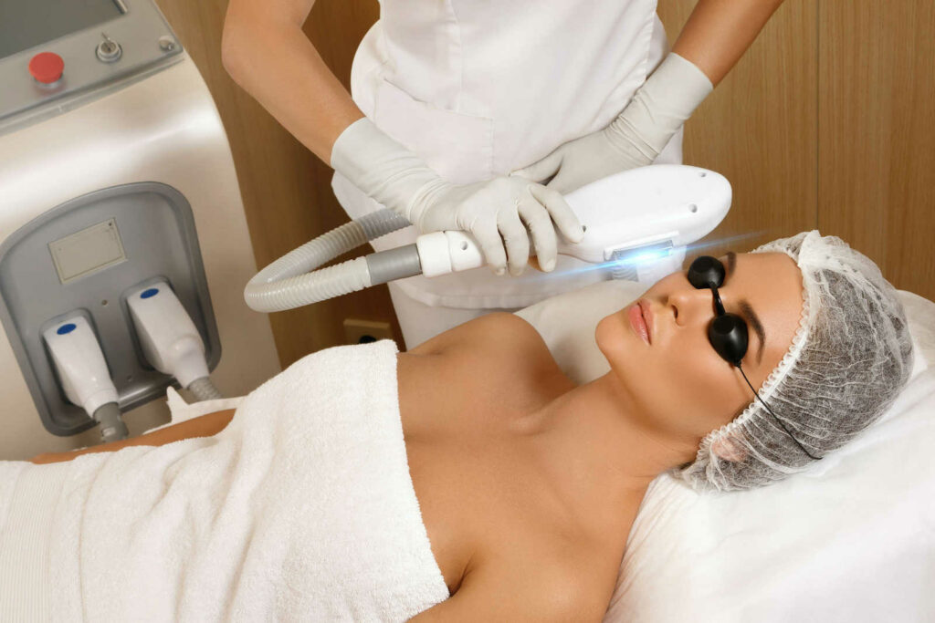 A woman receiving an IPL treatment while laying.